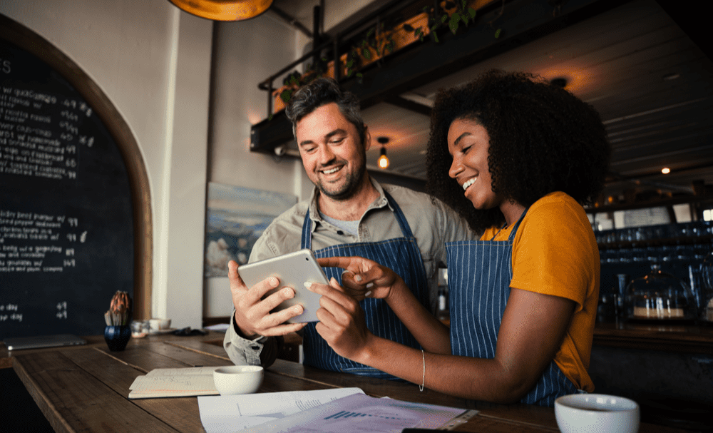 woman and man holding tablet