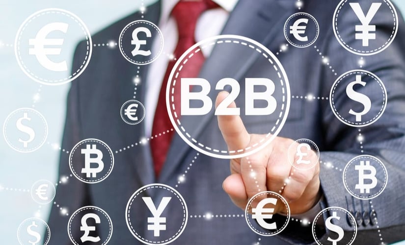 b2b written in the center linked to different currency symbols representing the b2b payment landscape